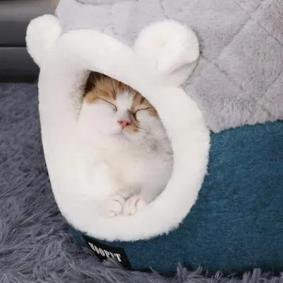 niche pour chats grise et bleue avec un chat couché